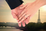 Composite image of close-up of bride and groom with hands together
