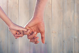 Composite image of loving young couple holding hands