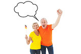 Composite image of happy german couple cheering at camera