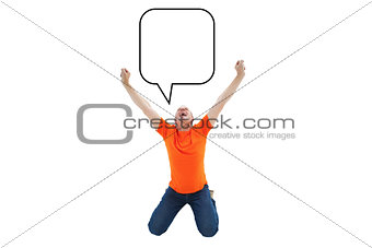 Composite image of mature man in orange tshirt cheering while kneeling