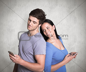 Composite image of young couple sending a text