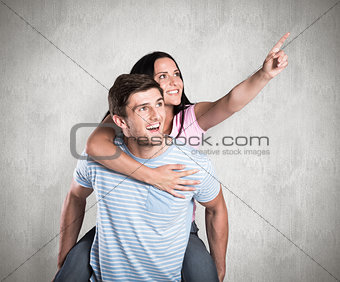 Composite image of young man giving girlfriend a piggyback ride
