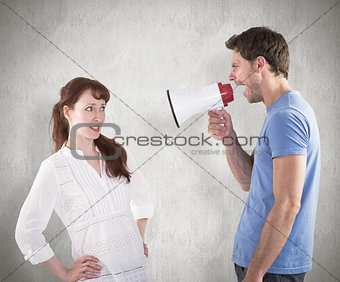 Composite image of man shouting through a megaphone