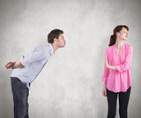 Composite image of woman stopping man from kissing