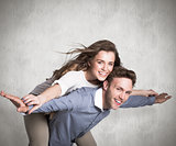 Composite image of smiling young man carrying woman