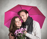 Composite image of cheerful young couple with flowers and umbrella