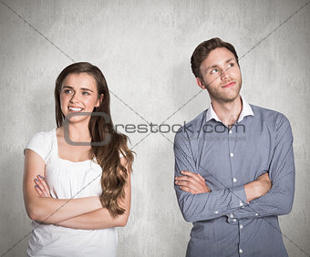 Composite image of smiling young couple with arms crossed