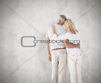 Composite image of happy couple standing and looking