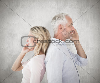 Composite image of happy couple talking on their smartphones