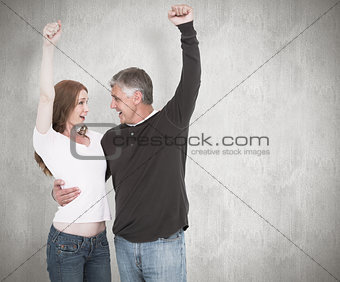 Composite image of casual couple cheering and smiling