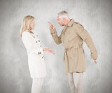 Composite image of angry couple fighting in trench coats