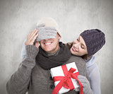 Composite image of woman surprising husband with gift