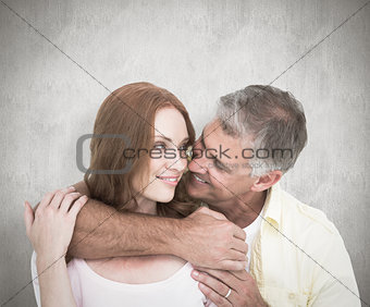 Composite image of casual couple smiling and hugging