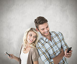 Composite image of attractive couple using their smartphones
