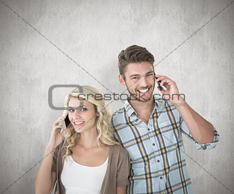 Composite image of attractive couple talking on their smartphones