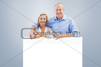 Composite image of mature couple smiling at camera