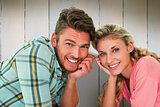 Composite image of attractive young couple lying and smiling at camera
