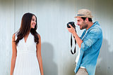 Composite image of handsome hipster taking a photo of pretty girlfriend