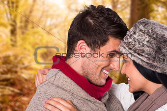 Composite image of young couple smiling and hugging