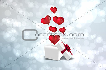 Composite image of hearts flying from box