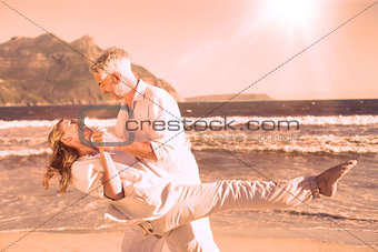 Happy couple dancing on the beach together