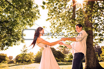 Loving young couple holding hands at park