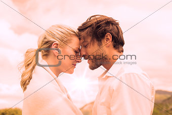 Cute smiling couple standing outside facing each other