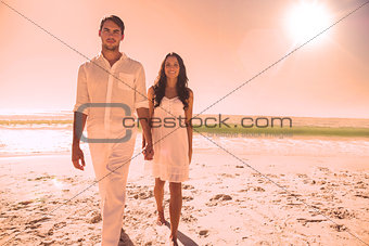 Beautiful couple holding hands and walking towards camera