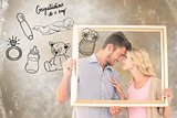 Composite image of attractive young couple holding picture frame