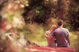 Loving couple admiring nature while leaning on their cabriolet