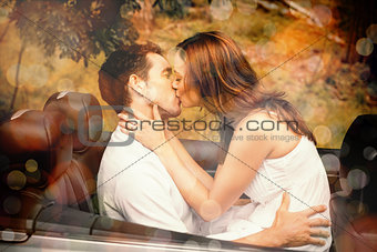 Beautiful couple kissing in back seat