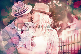 Hip young couple kissing by railings