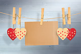 Composite image of hearts hanging on line with card