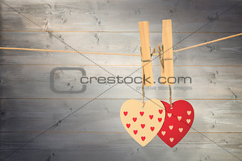 Composite image of hearts hanging on the line