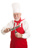 Mature Chef Sharpens Knife