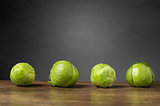 Four brussels sprouts on a row