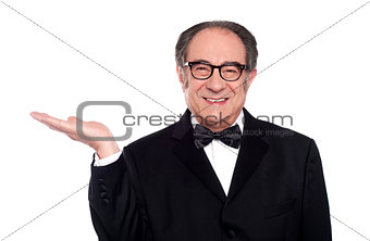 Man in party wear presenting copy space