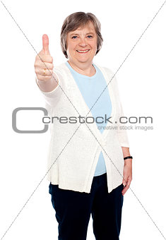 Smiling old lady showing thumbs up gesture