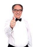 Smiling old man gesturing thumbs up