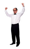 Excited senior man posing with raised arms