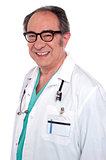 Matured male surgeon with stethoscope