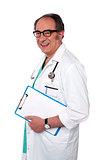 Senior male doctor holding blank clipboard