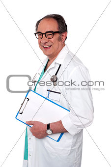 Senior male doctor holding blank clipboard