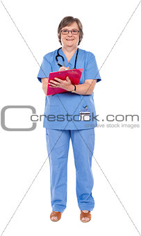 Senior female doctor writing on clipboard