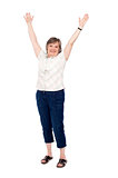 Cheerful senior woman lifting her arms up