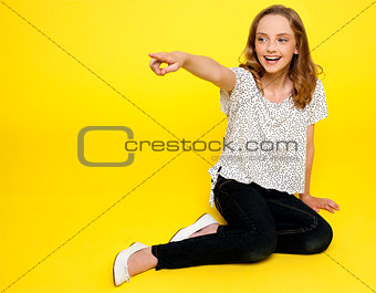 Cute isolated fashion girl pointing at something