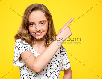 Smiling caucasian girl indicating upwards