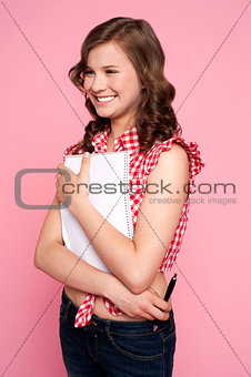 Trendy young girl posing with spiral notepad