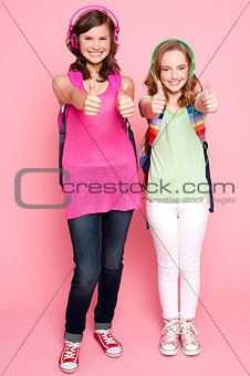 Happy teen girls showing thumbs up