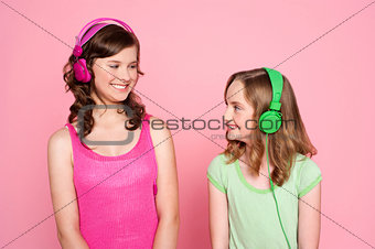 Two teenage friends enjoying music together